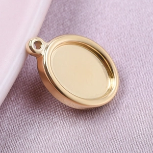 Detailed macro view of 18k gold plated oval charm base for DIY jewelry making