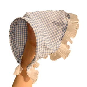 Blue and white plaid baby sun hat with delicate white ruffle trim and cotton fabric