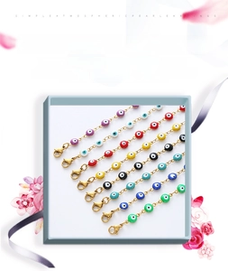 Detail showing eight colors of evil eye bracelets with golden stainless steel chains