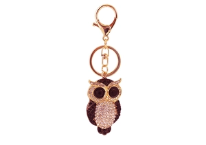 Close-up of golden owl keychain with sparkling rhinestones and black beaded eyes detail