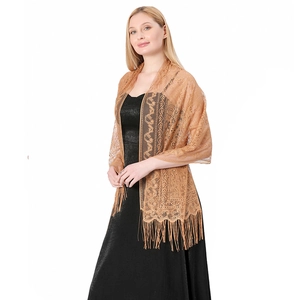 Detailed close-up of golden lace shawl with intricate paisley hollow patterns and long tassels