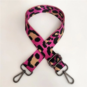 Macro view of wide leopard print replacement shoulder strap with dark metal hooks