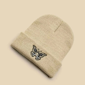 Unisex beige knit beanie hat with detailed butterfly embroidery for autumn and winter