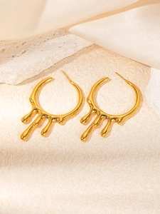 Detail of 18K gold plated liquid lava melt earrings on luxury silk and stone background
