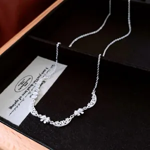 French style bow-knot pendant necklace with silver floral design and cubic zirconia