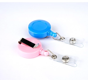 Detail of pink and blue retractable badge reels with metal clips and vinyl straps