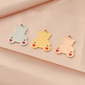 Mirror polished stainless steel bear pendants with red hearts on pink silk fabric