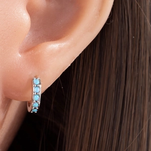 Polished silver huggie hoop earrings with five inlaid light blue opal gemstones for women