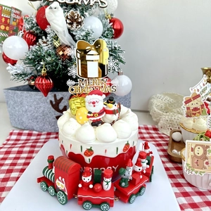 Golden Merry Christmas acrylic cake toppers with festive wood train on holiday dessert table