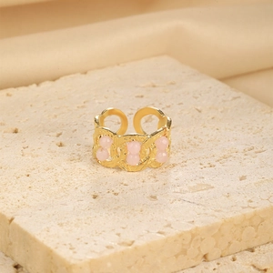 Detail of adjustable gold-plated chain ring featuring three round pink beads on stone base