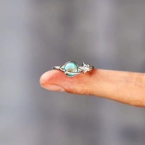 Close-up of S925 silver ring featuring blue planet gemstone and star design on finger