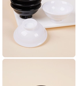 Close-up of stacked black and white miniature ramen bowls in 1:12 scale dollhouse style