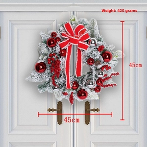 Detail of 45cm flocked Christmas wreath with red bow, berries and silver ornaments