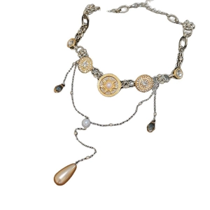 Luxury layered necklace with sun motif, pearls, and teardrop amber crystal pendants