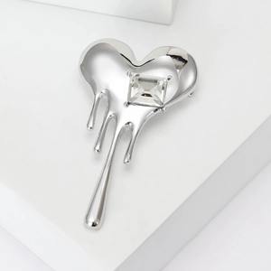 Polished silver melting heart brooch with rectangular crystal stone in a minimalist style