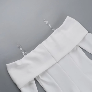 Detail view of off-shoulder white dress featuring adjustable clear plastic shoulder straps