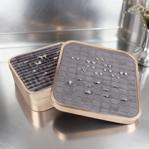 Stackable metal jewelry display tray in champagne gold with grey velvet ring inserts