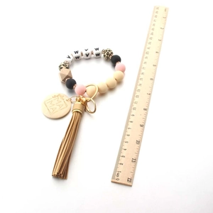 Detail of MAMA beaded keychain wristlet with ruler showing 22cm total length measurement