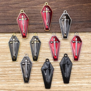 Detailed view of Gothic coffin pendants with crosses in red and black enamel finish