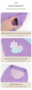 Detail of purple pet sweater featuring rainbow unicorn embroidery and elastic knit fabric