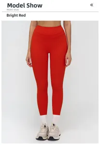 Front view of model wearing bright red high-waisted fitness yoga leggings in studio light