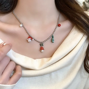 Christmas themed necklace with red bells and green trees on a silver beaded chain