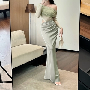 Detail of light green off-shoulder mesh top paired with a silky satin maxi skirt