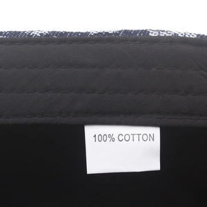 Close-up of 100% cotton material tag and blue checkered fabric of the newsboy cap