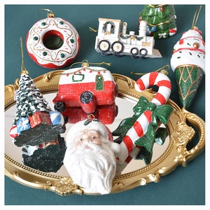 Close-up of festive Christmas tree ornaments including Santa, candy canes and donuts