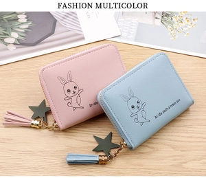 Close-up of mini PU leather coin purses with bunny print, star charm, and tassel detail