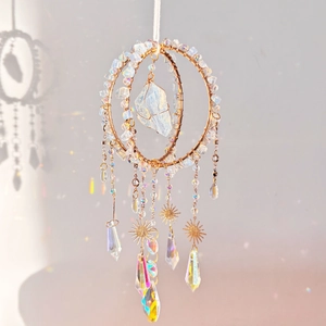 Detailed close-up of handmade moonstone suncatcher with prisms casting rainbows on the wall