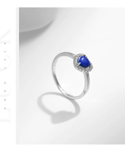 Macro shot of S925 sterling silver ring featuring a blue heart opal stone and S925 hallmark