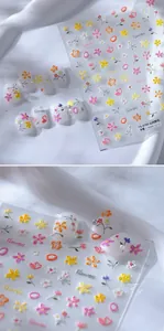 Macro detail of 3D embossed wild flower nail art stickers with textured floral patterns