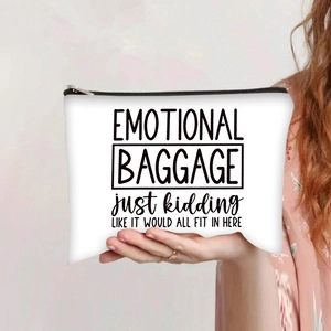 Close-up of white canvas makeup bag with black Emotional Baggage print and zipper detail