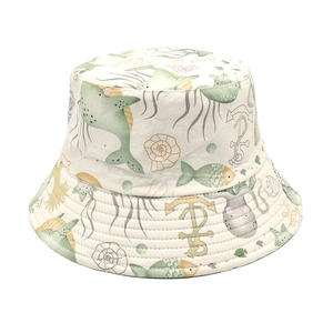 Reversible bucket hat with white marine sea life print and yellow fish patterns