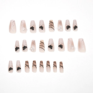 Pink gradient press-on nails with black butterfly patterns and silver glitter lines