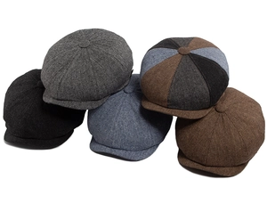 Close-up of five retro newsboy caps in various colors with textured wool blend fabric