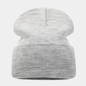 Close-up of a light gray knit beanie showing fine ribbing and wide folded cuff texture