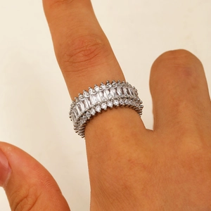 Detail of multi-row micro-pave heart ring with cubic zirconia on a model's finger