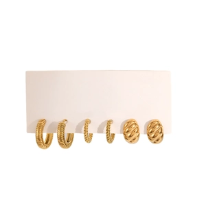 Three pairs of golden twisted hoop earrings displayed on a white product card