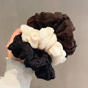 Three-piece set of textured bubble fabric scrunchies in black, white, and coffee brown colors