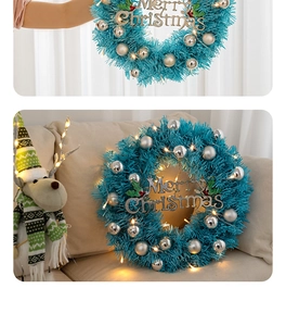 Detail of blue Christmas wreath with silver baubles and warm LED lights decoration