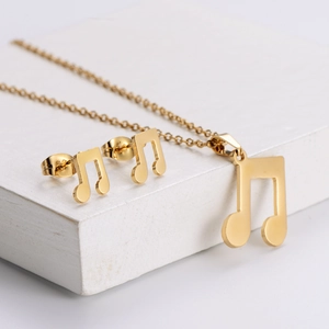 Golden stainless steel music note jewelry set featuring polished necklace and stud earrings
