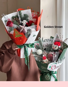Detail of Christmas apple bouquet with red roses, pine cones and Merry Christmas wrapping