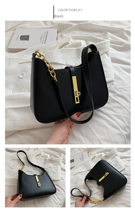 Detail view of black PU leather underarm bag with gold chain strap and rectangular lock
