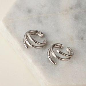 Minimalist S925 sterling silver triple layer spiral ear cuff on white marble background