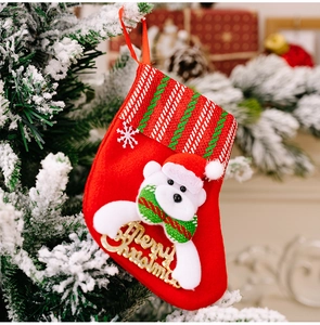 Close-up of red Christmas stocking with white polar bear and golden Merry Christmas text