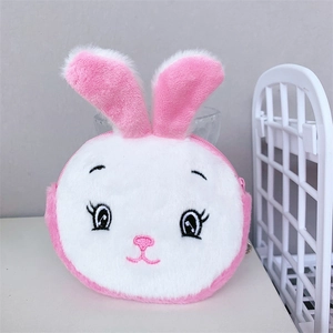 Close-up of pink plush bunny coin purse featuring detailed embroidery and top ears