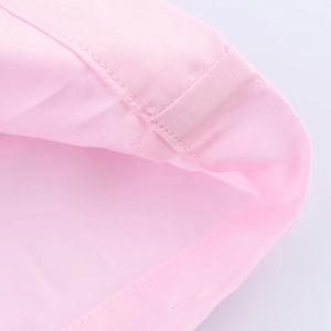 Detail showing high-quality stitching on pink poplin fabric for women's casual shirts