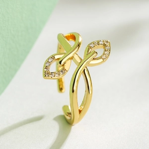 18K gold plated leaf ring with shimmering cubic zirconia stones on a bi-color background